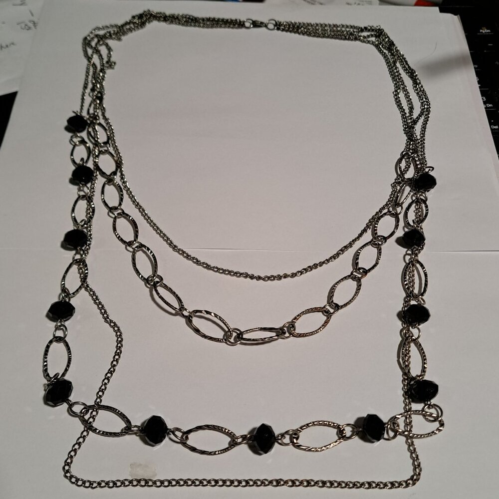 long silver and black chain with oval designs. multistrand necklace